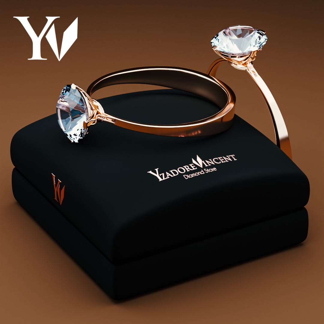 Two rose gold engagement rings with large solitaire diamonds displayed on a black velvet Yzadore Vincent jewelry box