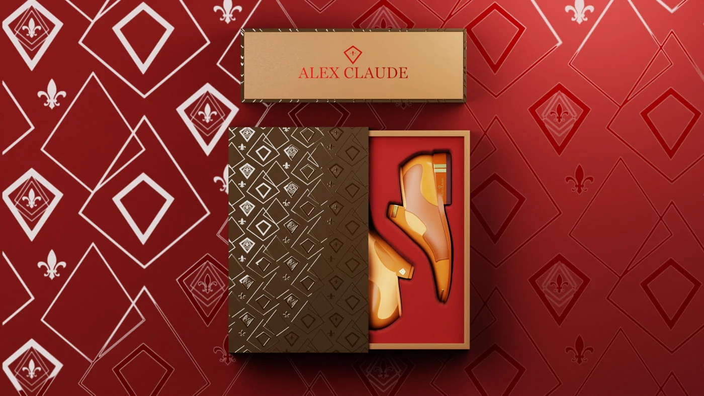 alex-claude-shoe-box-packaging-design Gold and brown Alex Claude shoe box open on a red patterned background.