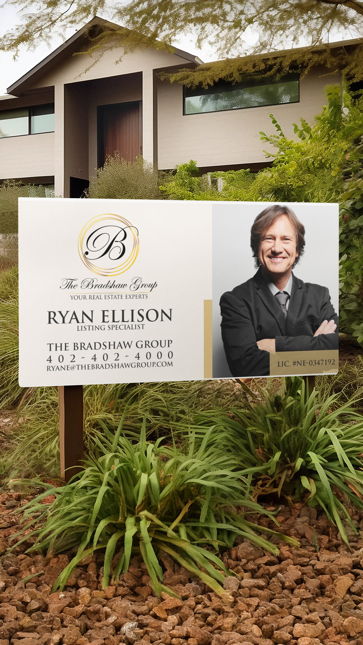 Real estate yard sign in front of a listed home displaying a gold and black branding logo, agent photo, and phone number.