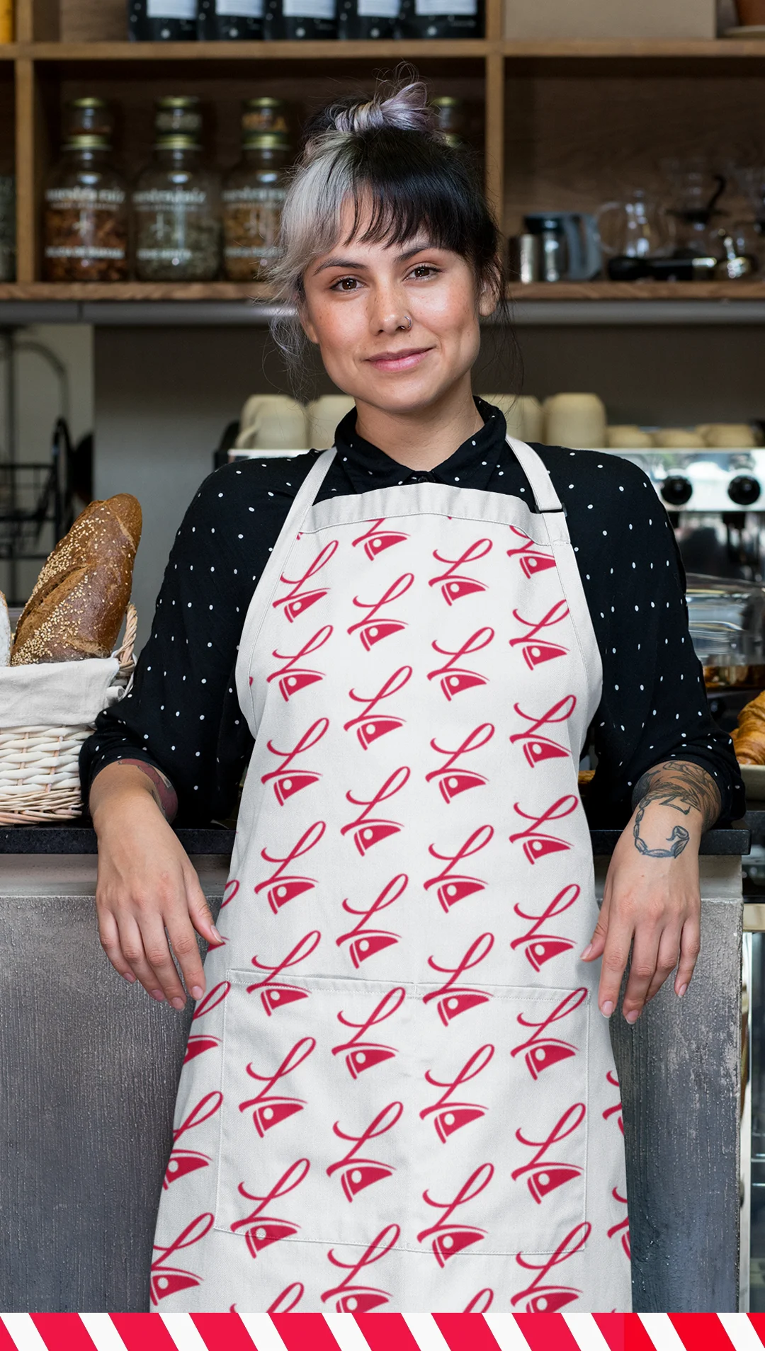 pizza-restaurant-branding-apron-for-servers Woman in a patterned Lorenzo's logo apron standing behind a bakery counter.