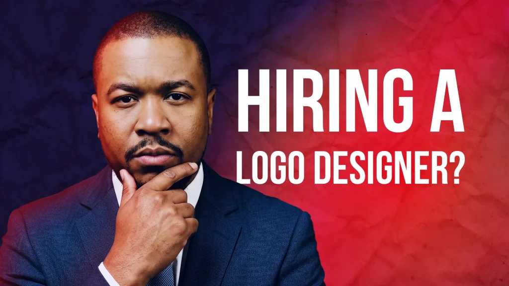 YouTube thumbnail of a man in a navy suit with a skeptical expression, hand on chin, against a navy-to-red textured background, with bold white text reading 'Hiring a Logo Designer?