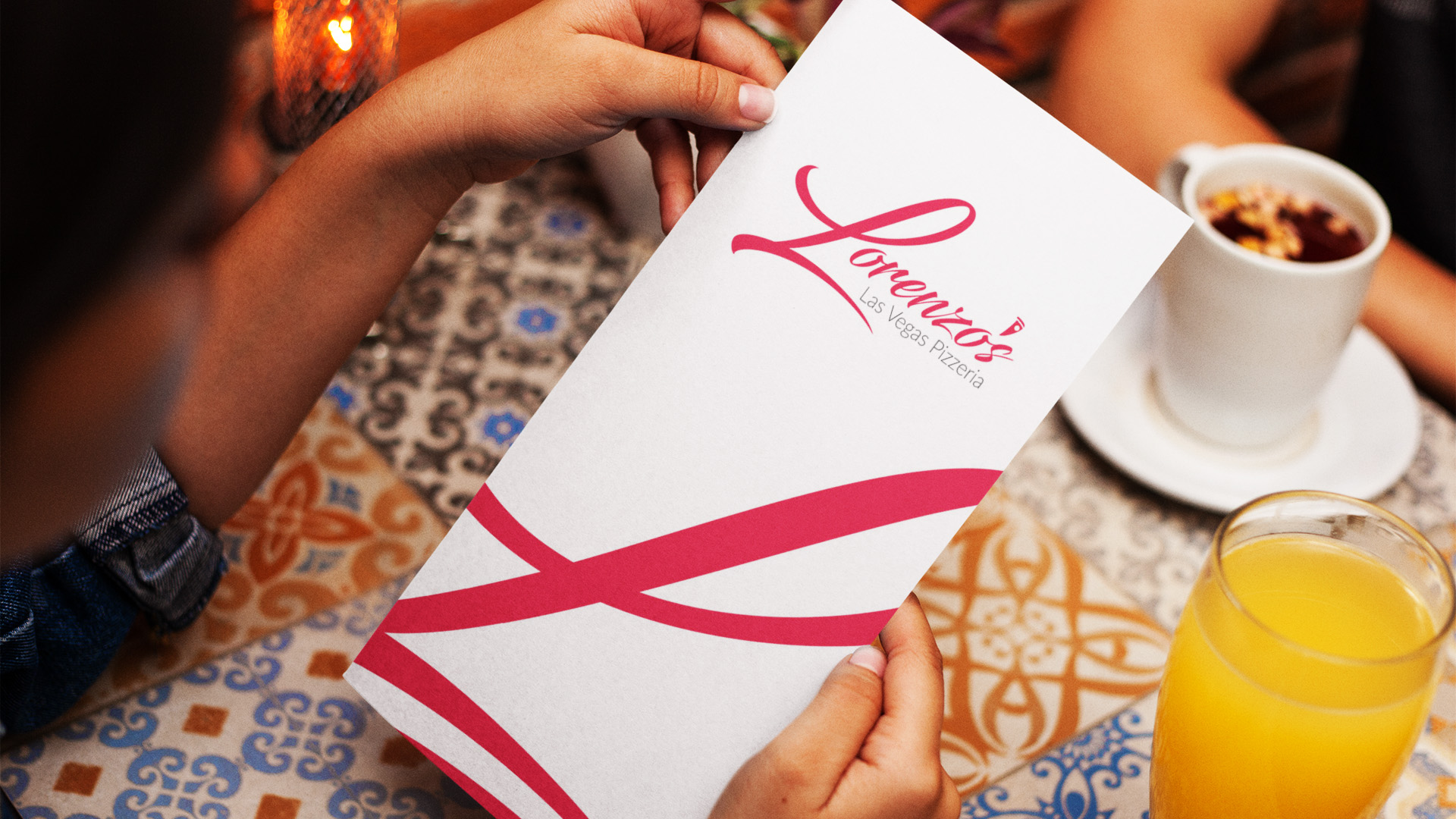 Restaurant Menu Design Lorenzo's Las Vegas Pizzeria menu cover with the script logo and a sweeping red ribbon graphic on white stock