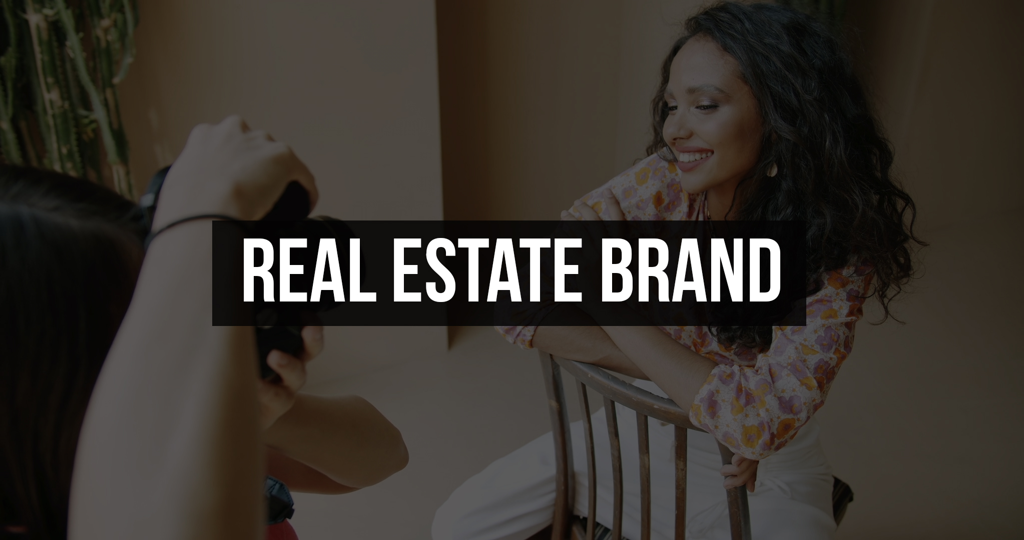 Real Estate Brand Services Photographer shooting a smiling woman on a chair during a personal brand photoshoot, with the title "Real Estate Brand"