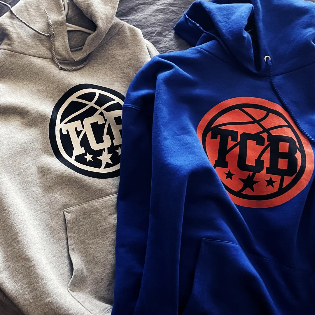 TCB basketball hoodies industry design Gray and royal blue hoodies printed with a TCB basketball logo and three stars.