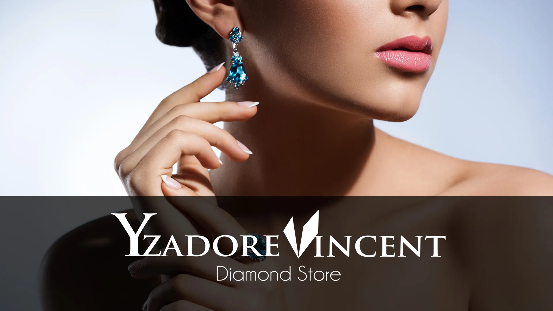 Yzadore Vincent diamond store industry design Woman touching her neck while wearing a blue gemstone drop earring and ring.